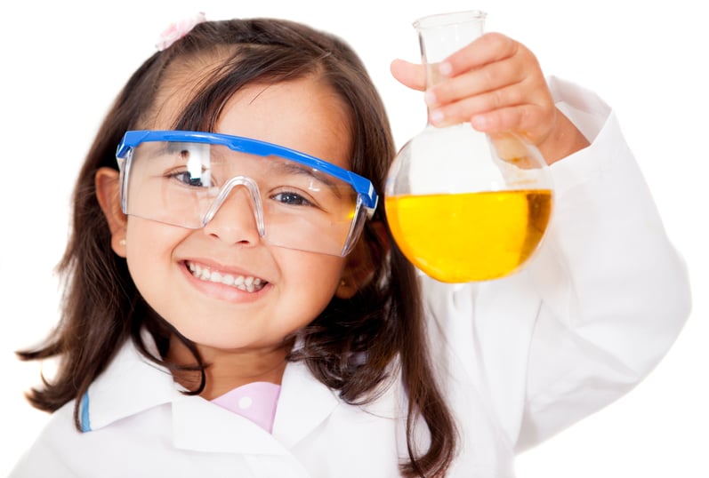 Happy little girl playing at the lab - isolated over white