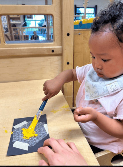 Toddler taking part in a sensory learning experience