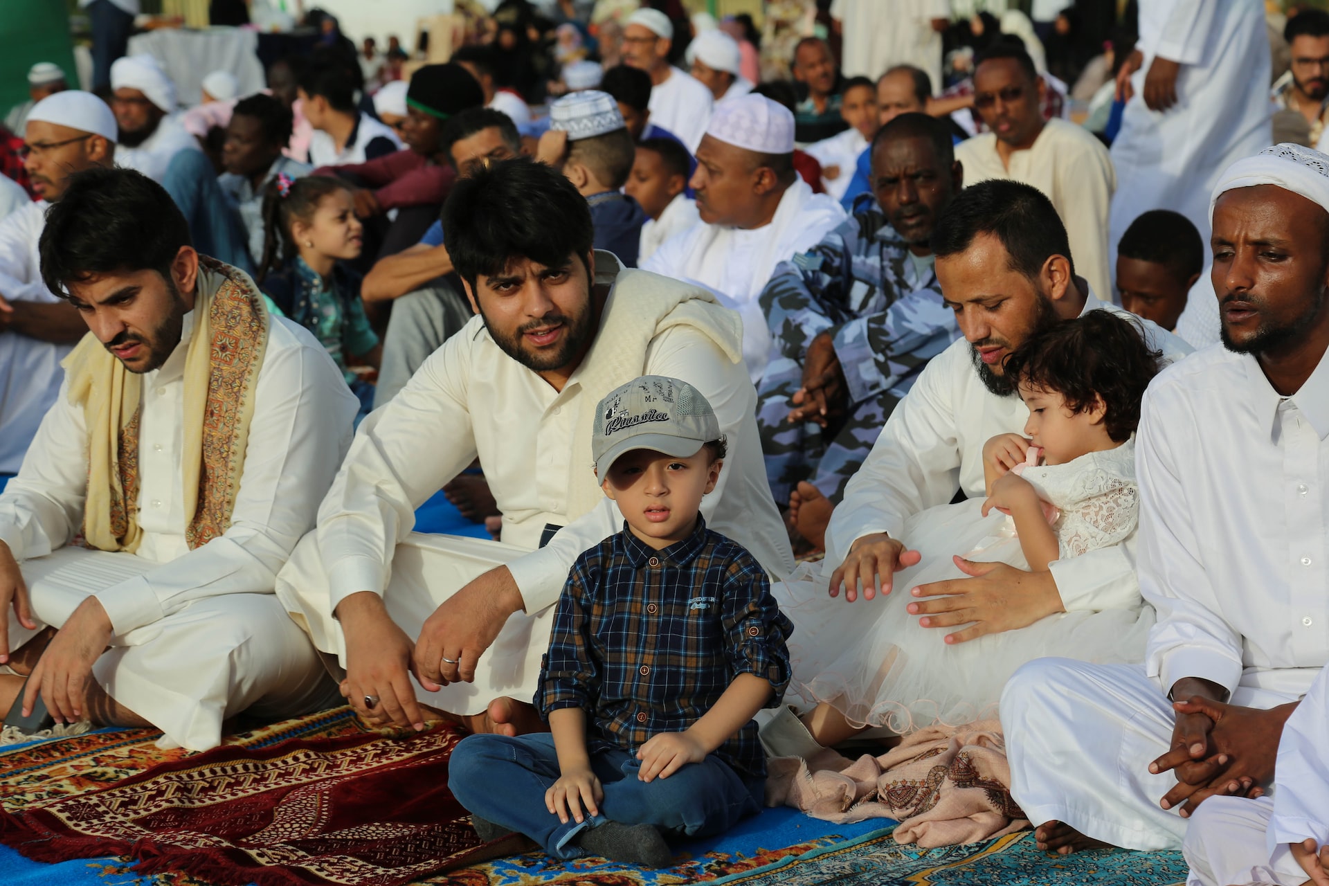 Young children celebrating ramadan with their fathers