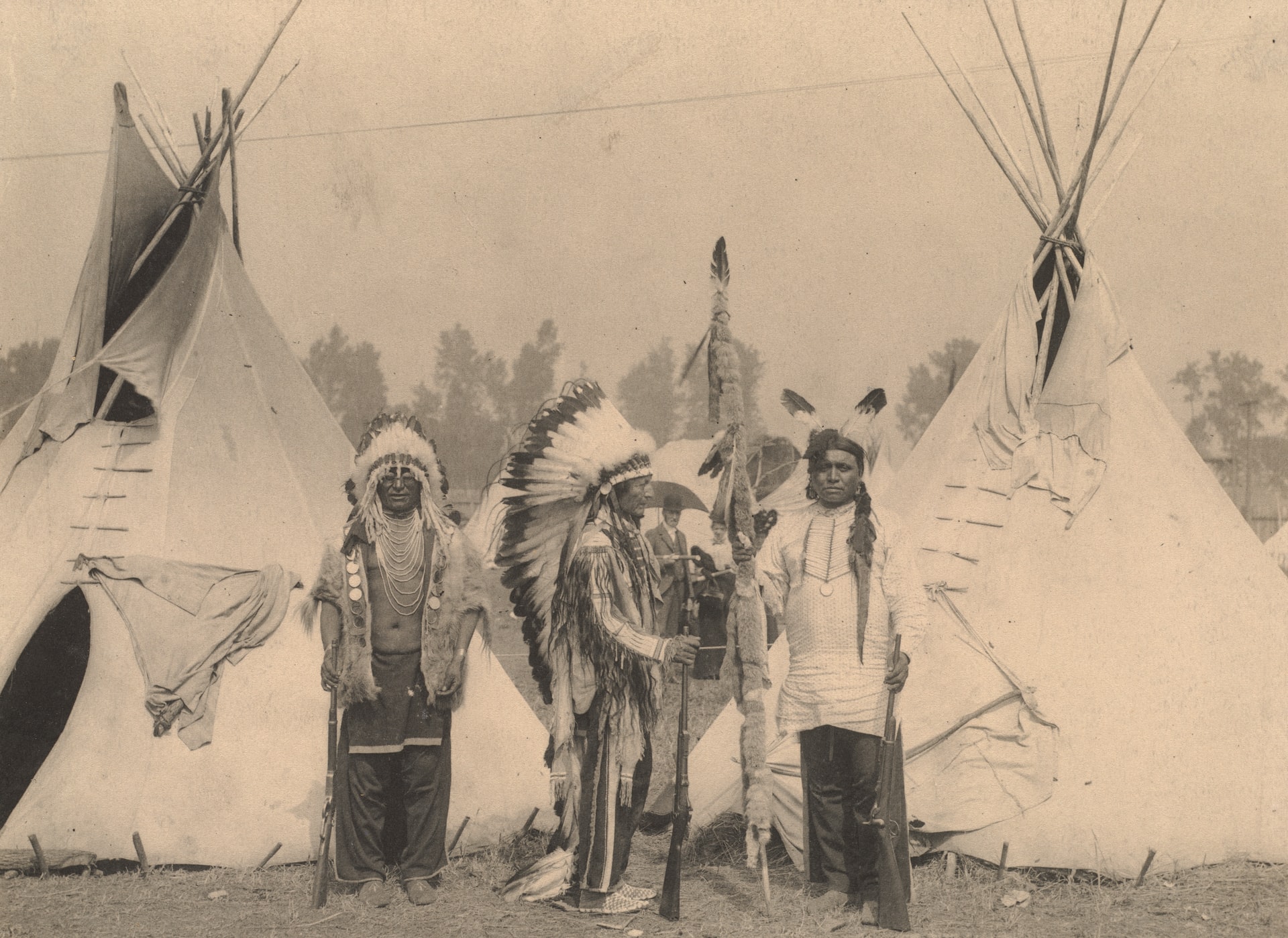 members of the Sioux American Indian tribe stand in front of tipis