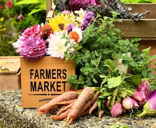 Sweet potatoes, radishes and flowers in a farmers market box